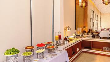 A buffet setup with various food items and a coffee station.