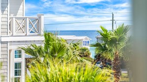 A coastal residential area with white houses, palm trees, and a view of the ocean. - Large Family Getaway – Pool, Golf Cart, Sleeps 17 (Santa Rosa Beach)