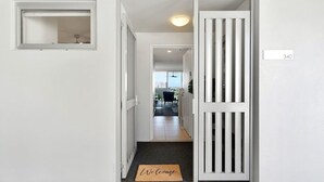 A hallway with a door marked 340, a welcome mat, and a window with blinds. - Balcony Views, Parking, Pool & Gym | Walk to CBD (Spring Hill)