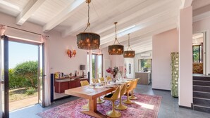 A spacious dining area with a long wooden table, multiple chairs, and a patterned rug. - Villa Belvedere Condor  - S, Alassio, Italy (Alassio)