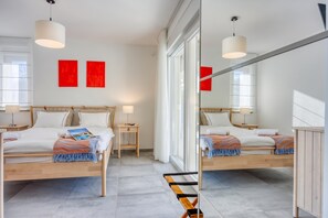 A modern hotel room with two beds, a large mirror, and red artwork on the wall. - Pool Villa Ora in Nature, Rakalj, Croatia (Rakalj)