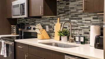 Dishwasher, coffee/tea maker, cookware/dishes/utensils, dining tables