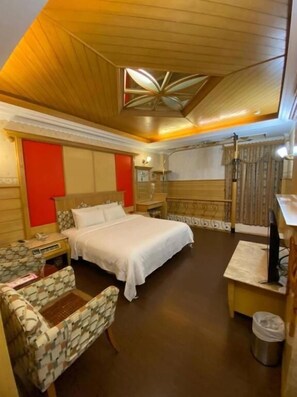 A hotel room with a bed, a desk, a chair, a TV, and a bathroom. - Ailv Motel II (Kaohsiung)