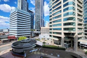 A modern urban area with high-rise buildings, a circular structure with a glass roof, and a pedestrian walkway. - Properkey Realty (Chatswood)