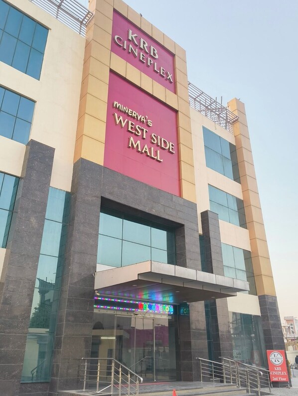 A modern building with a prominent sign for 'KRB CINEPLEX' and 'Minerva's West Side Mall'. - Hotel KRB Greens (Bahadurgarh)