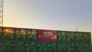 A hotel sign with a lush green hedge backdrop. - Hotel KRB Greens  (Bahadurgarh)