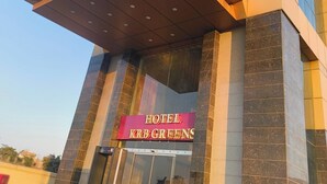 A modern hotel entrance with a prominent sign reading "HOTEL KRBGREENS". - Hotel KRB Greens  (Bahadurgarh)