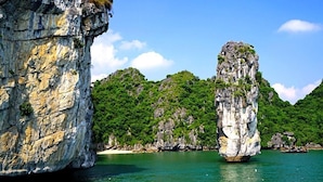 A coastal landscape with limestone cliffs and a clear blue sea. - Alex Halong Hotel & Hostel (Bai Chay)