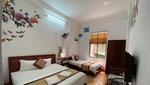A hotel room with two beds, a TV, a desk, and a chair. - Alex Halong Hotel & Hostel (Bai Chay)