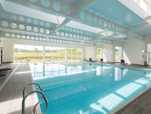 An indoor swimming pool with clear views of the outdoors, a tiled floor, and a metal ladder. - 3 bedroom accommodation in Carbis Bay, near St Ives (Carbis Bay, near St Ives)