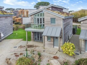 A modern two-story house with a balcony, a small garden, and a stone pathway. - 3 bedroom accommodation in Carbis Bay, near St Ives (Carbis Bay, near St Ives)