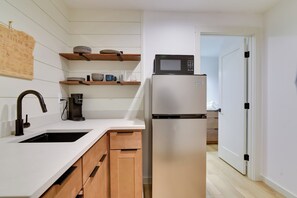 Fridge, microwave, coffee/tea maker, cookware/dishes/utensils