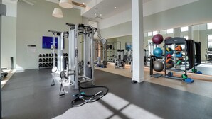 A gym with exercise equipment, weight racks, and a mirror. - Pool Access! Luxe Condo 7 Mi to Coquina Beach (Bradenton)
