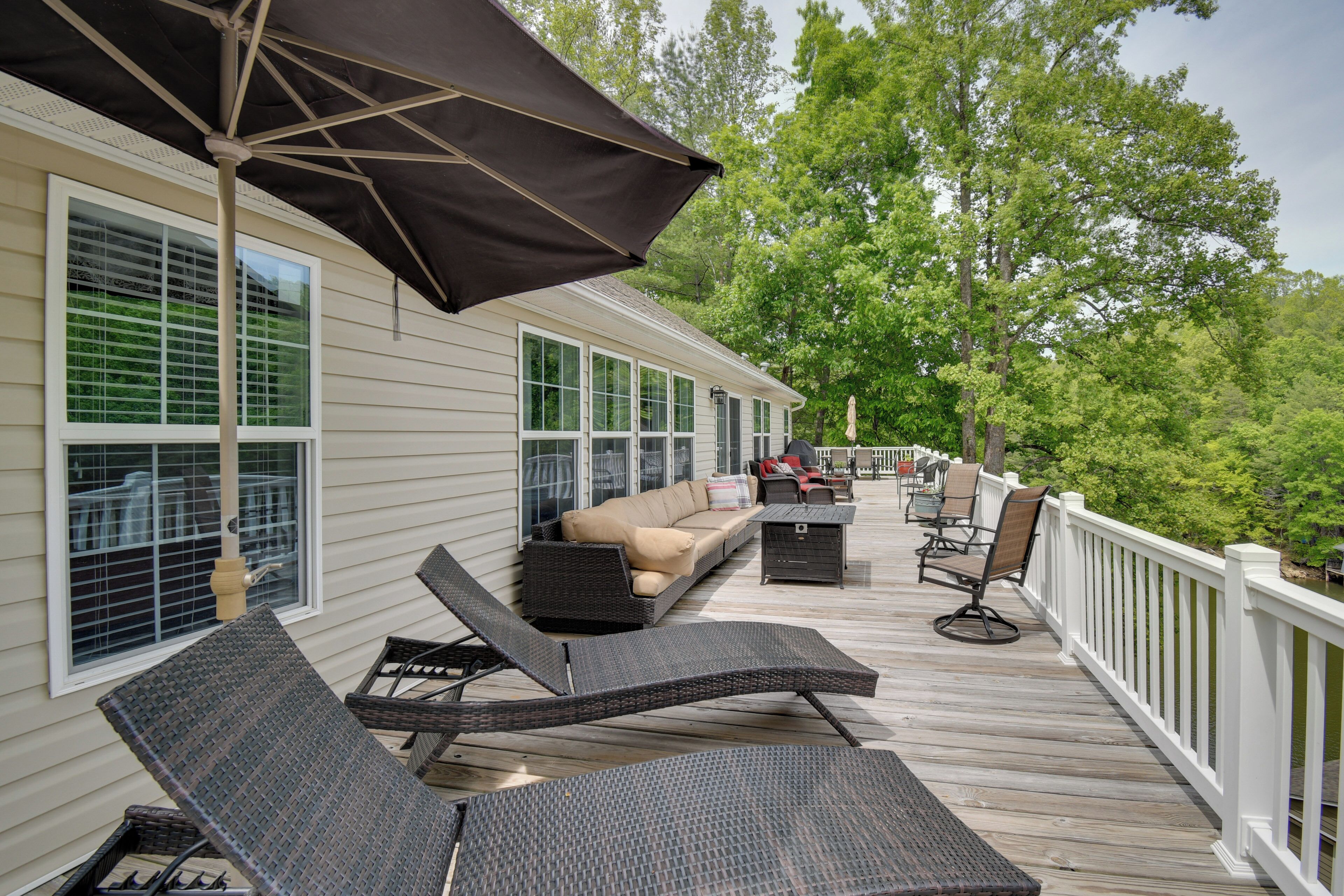 Une terrasse couverte, aménagée avec du mobilier d’extérieur, un canapé et un coin repas.