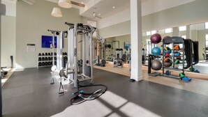 A spacious gym with various exercise equipment, including a cable machine and weight plates. - Resort Perks! Family Condo 3 Mi to IMG Academy (Bradenton)