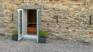 A stone building with a door leading to an interior room. - 2 bedroom accommodation in Barnard Castle (Barnard Castle)