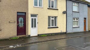 A row of terraced houses with distinct front doors and windows.