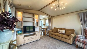 A cozy living room with a television, sofa, and a dining area. - 2 bedroom accommodation in Hartshorne (Hartshorne)