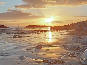 A beach with rocks and a sunset. - 1 bedroom accommodation in Bognor Regis, near Chichester (Bognor Regis)
