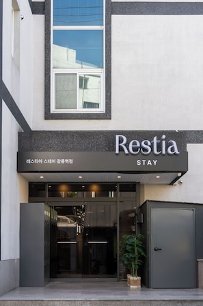 A building with a sign reading 'Restia Stay' and a glass entrance. - RESTIA STAY GANGNEUNG STATION (Gangneung)