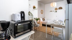 A modern kitchen with a coffee maker, toaster, and microwave on the counter. - Orchid Cozy Studio & Balcony in Larnaca (Larnaca)