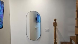Una escalera de madera con barandilla que lleva a un piso superior.