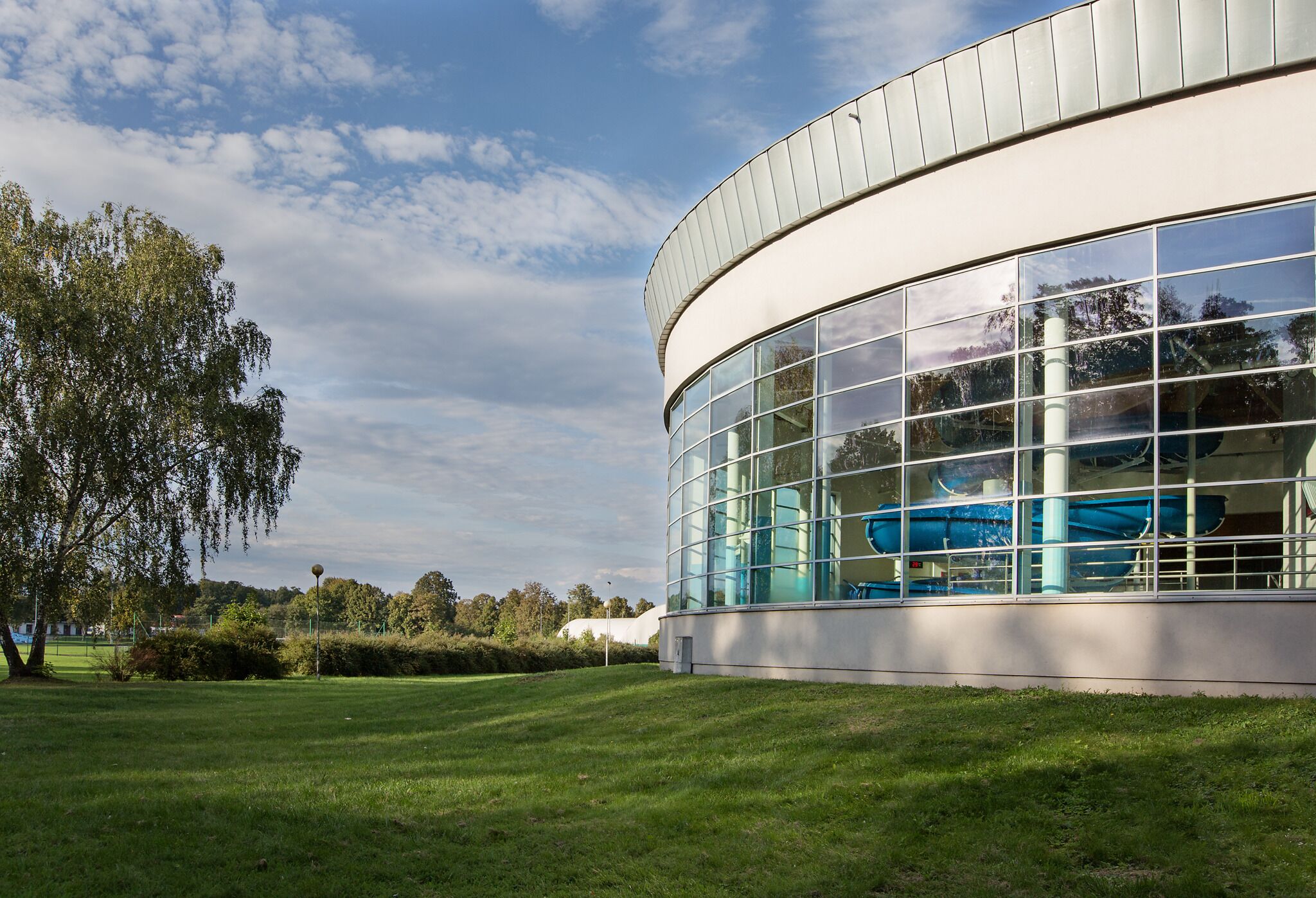 Un edificio moderno con ampie vetrate e facciata curvilinea.
