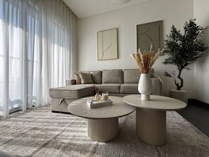 Deluxe Apartment, Balcony, Courtyard View | Living area | 65-inch Smart TV with digital channels, Netflix, streaming services - Luxury 1BR Apartment with Pool Access (Dubai)