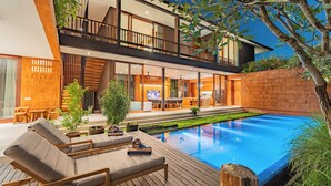 A modern two-story house with a swimming pool, outdoor seating, and a well-maintained garden. - Rosa Village (Jimbaran)