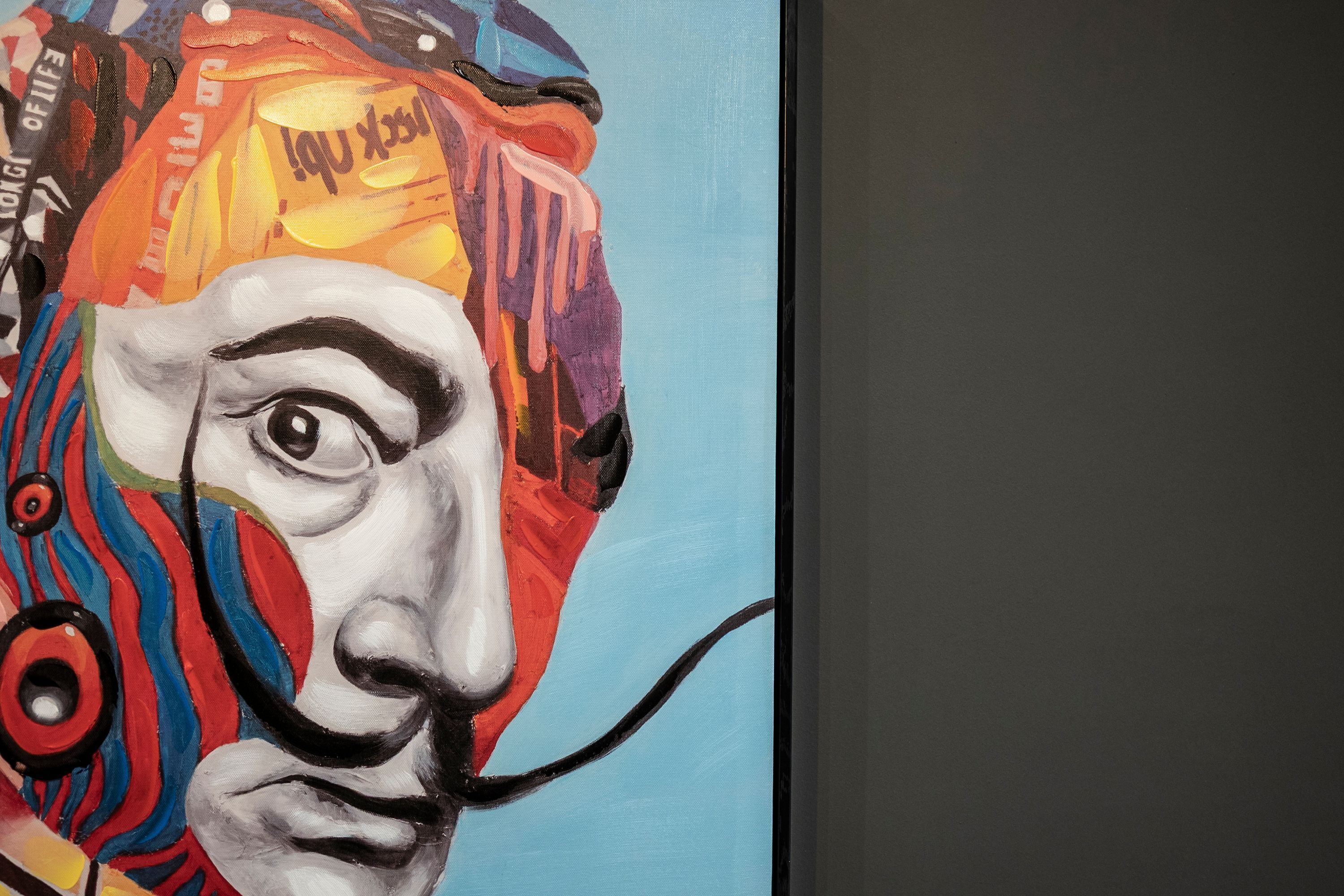 A colorful abstract painting with a prominent eye and a mustache.