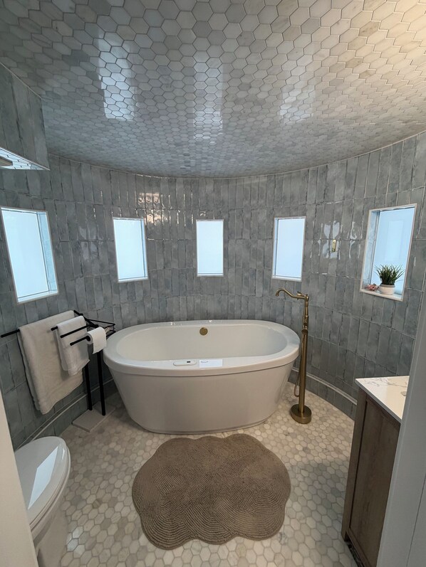 Jetted bath, hair dryer, towels, toilet paper