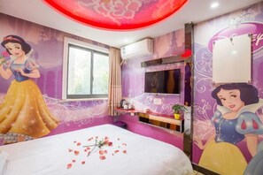 A room with a bed, a window, an air conditioning unit, and a wall with a Disney princess mural.