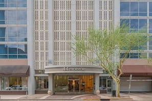 A modern building with a large glass facade, a sign reading '44 monroe,' and a tree in front. - Stylish ASU Stay Pool Gym Balcony Parking WD (Phoenix)