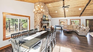 A spacious living area with a wooden ceiling, a fireplace, a television, and a foosball table. - Custom Log Style Cabin! Foosball! BBQ! Decks! Fenced Yard! (Big Bear Lake)
