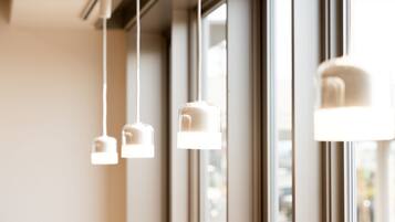 A window with three hanging pendant lights.
