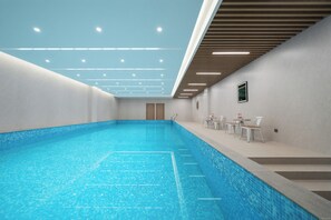 A swimming pool with a tiled floor and a ceiling with recessed lighting. - Shanghai Joy International Resort Hotel (Wild Animal Park) (Shanghai)