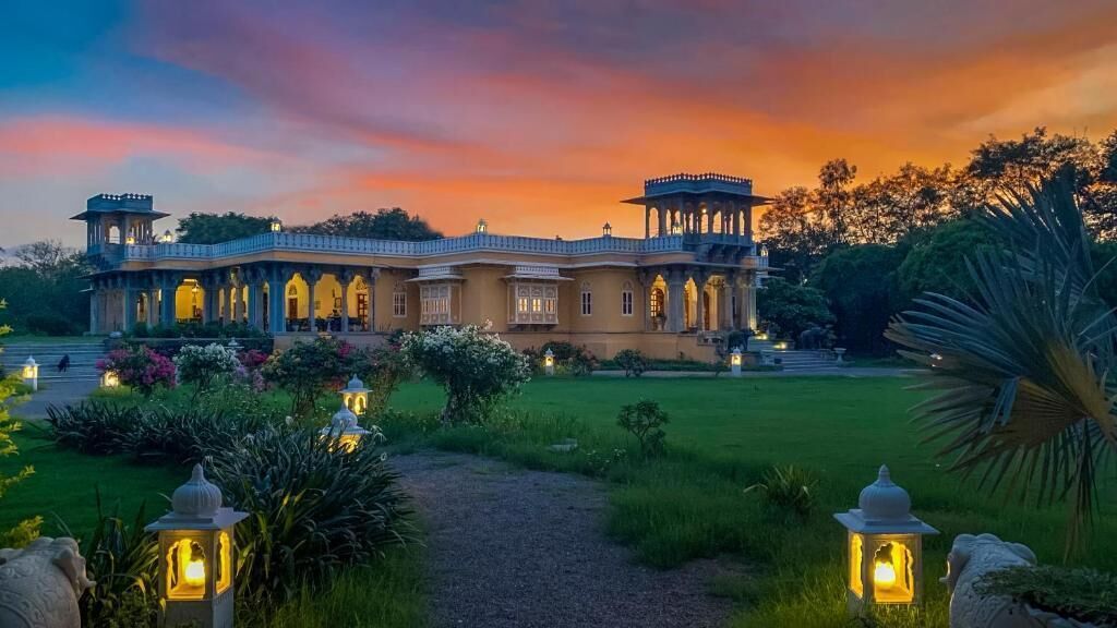 A grand building with a symmetrical facade, multiple arches, and a central pavilion.