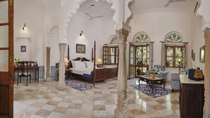 A traditional room with a checkered floor, a bed, a desk, and a sofa. - Dev Shree Deogarh (Devgarh)