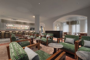 A modern lounge area with seating, a bar, and a television. - 1926 Heritage Hotel Penang By The Unlimited Collection (George Town)