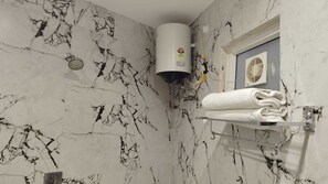 Deluxe Room | Bathroom | Shower, slippers, towels, soap - SHRI GAURANAG PALACE  (Vrindavan)