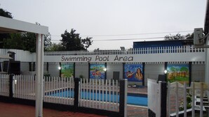 A swimming pool area with a white fence and a sign that reads "Swimming Pool Area." - Daeka Guesthouse (Kempton Park)