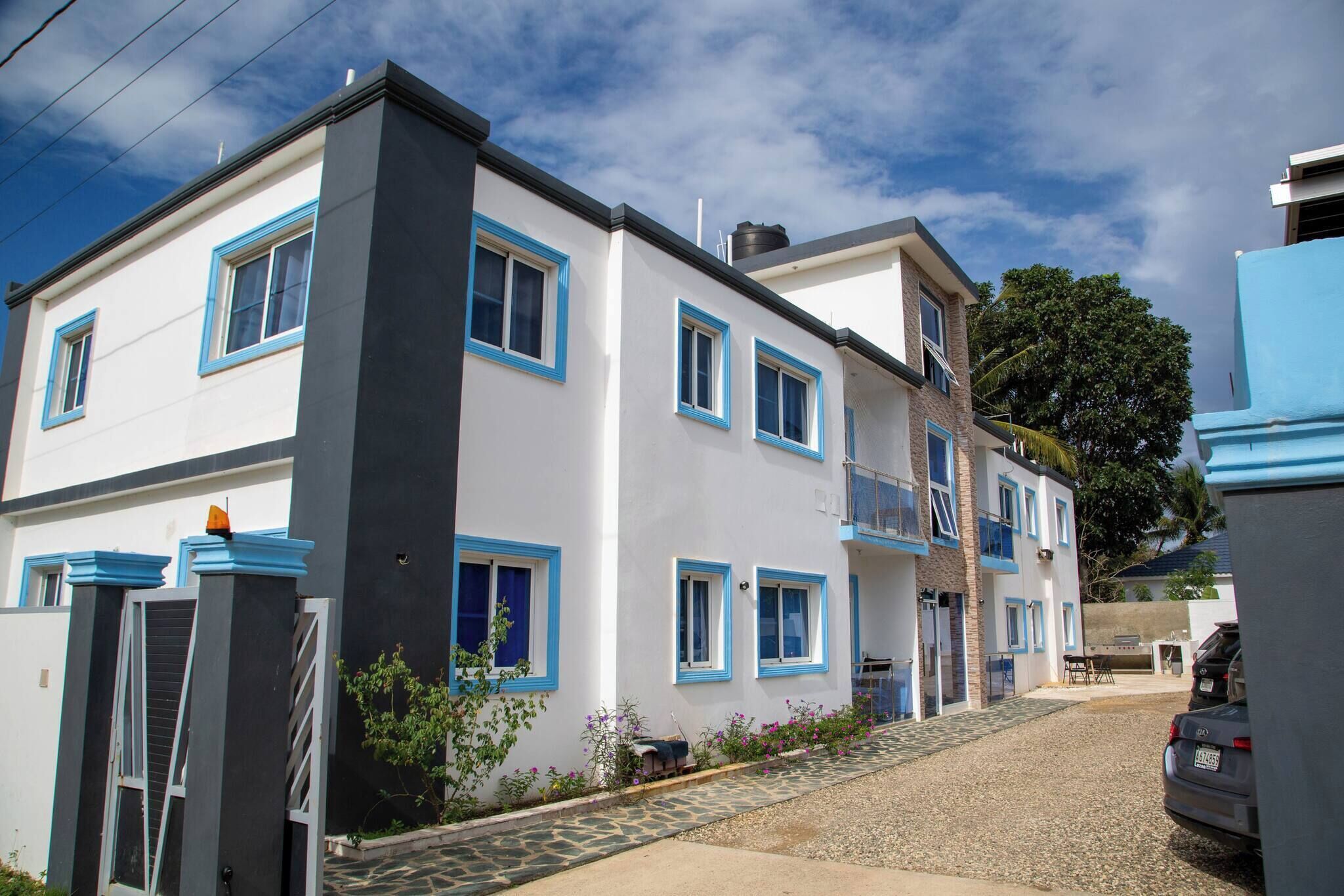 A two-story building with a white facade and blue trim.