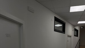 A hallway with white walls, numbered doors, and a marble floor. - ROOMS 78 (Castel di Sangro)