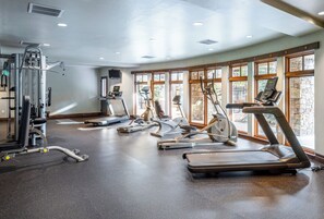 A gym with various exercise equipment, large windows, and a speckled floor. - 2BR Canyons Ski-in/Ski-out With Resort Amenities (Park City)