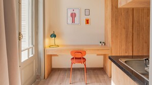 A compact kitchen with a wooden countertop, a single chair, and a small sink. - Brassbell Zamalek Daoud Studios Villa A (Cairo)