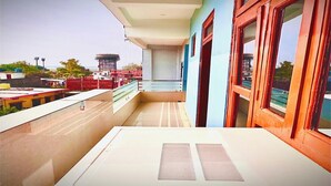 Un balcone con vista su un cantiere e un edificio sullo sfondo.
