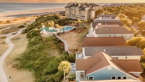 A coastal hotel with multiple buildings, a swimming pool, and a beach path. - High Tide | Oceanfront 3BR with Pool & Beach Access | Ocean Point (Isle of Palms)