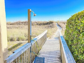 A wooden boardwalk leading to a beach with a clear sky. - Beach Villas at Cherry Grove C (North Myrtle Beach)