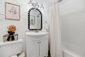 A bathroom with a white sink, vanity, and a mirror with lights. - Timbers Studio 34 with Wintergreen Advantage (Wintergreen)