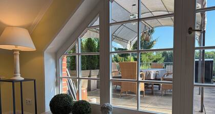 Apartment with large roof terrace, fireplace and carport by the Biesenthal Basin